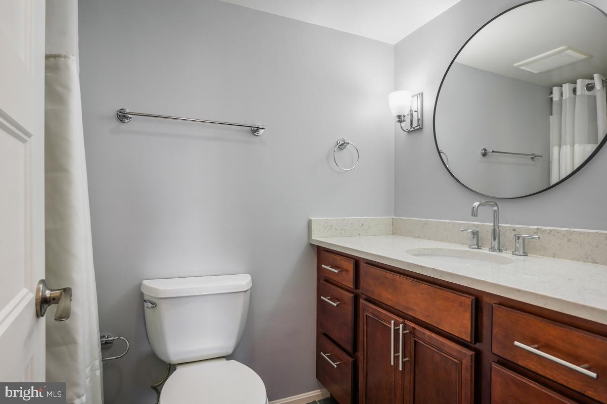 5902 Mt Eagle Drive, Unit 1615 Alexandria, VA 22303 - Photo 42 of 48 a bathroom with a toilet a sink and mirror