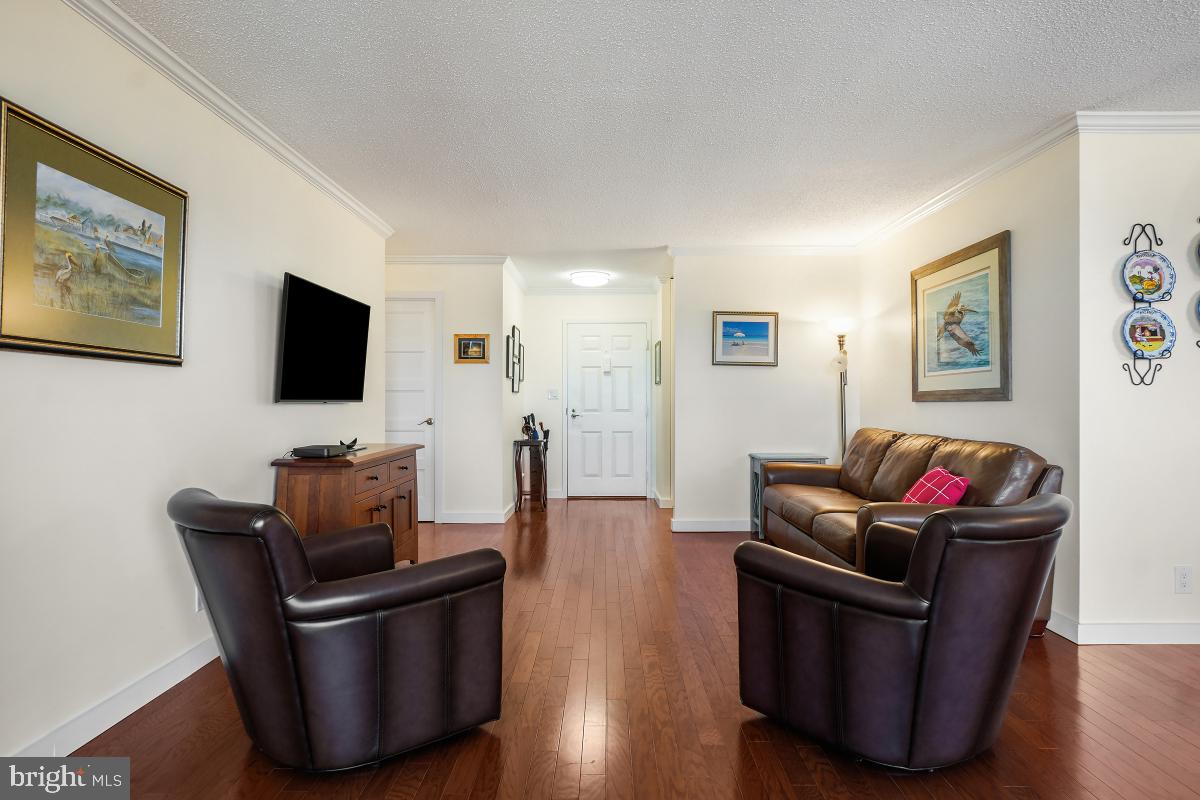 5902 Mt Eagle Drive, Unit 1615 Alexandria, VA 22303 - Photo 9 of 48 a living room with furniture and a flat screen tv