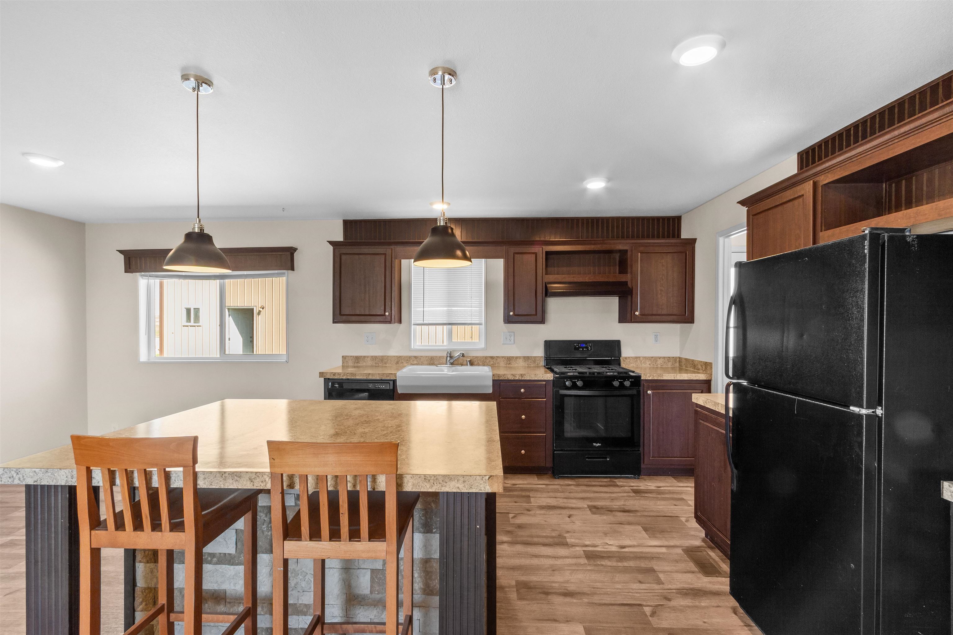 759 33 Road Clifton, CO 81520 - Photo 10 of 35 a kitchen with stainless steel appliances granite countertop a refrigerator a stove a sink dishwasher a dining table and chairs with wooden floor