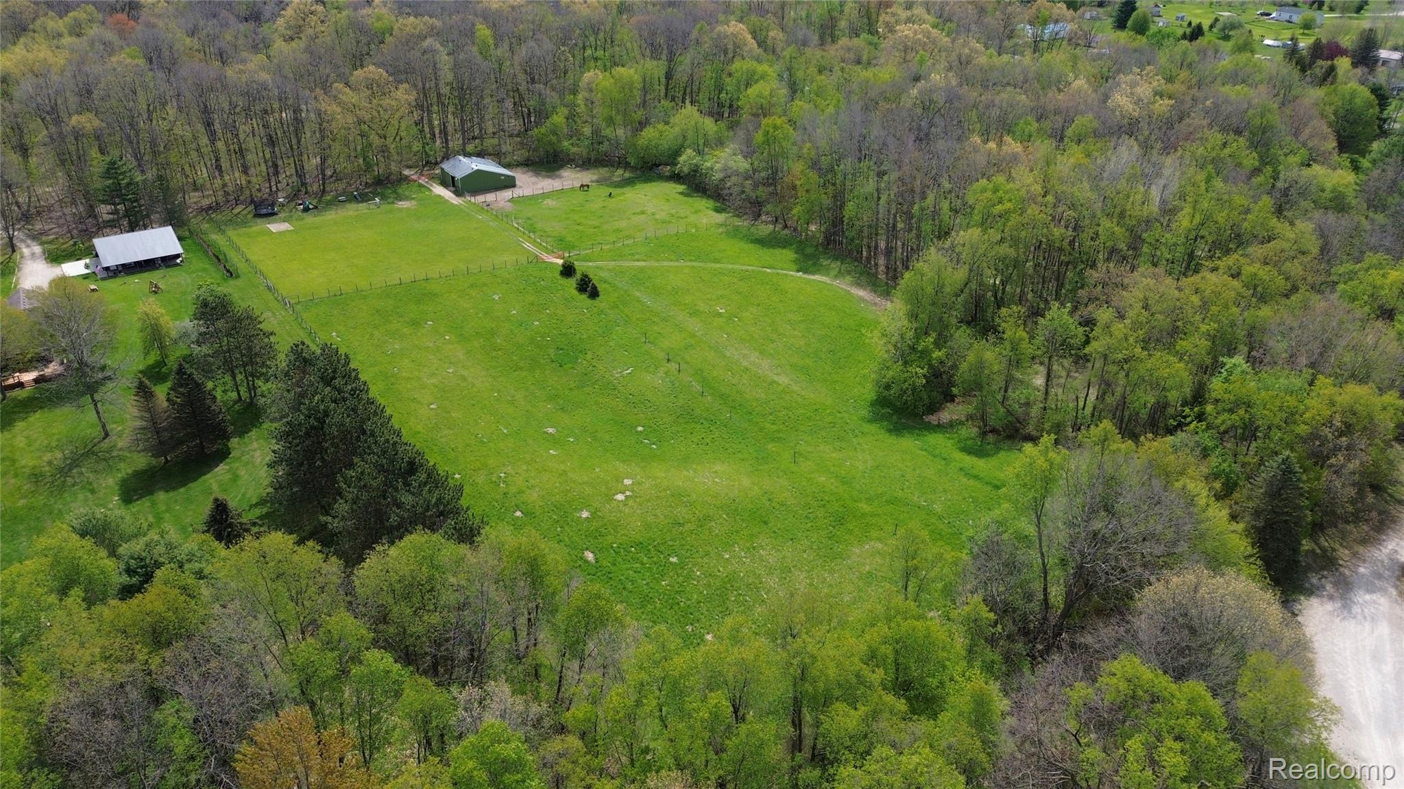 3910 Joy Road Metamora, MI 48455 - Photo 23 of 26 Aerial view of sparsely populated area with a heavily wooded area