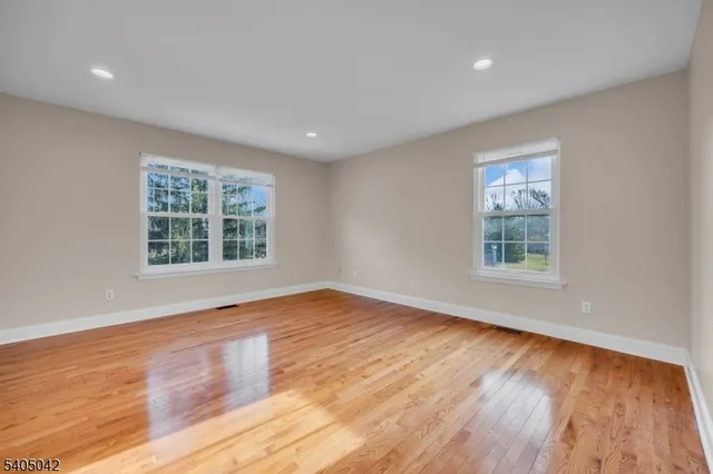 a bathroom with a granite countertop sink toilet a mirror and shower