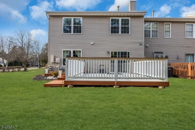 a view of a house with wooden deck