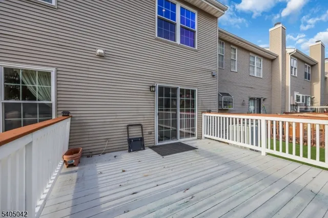 a view of a hallway view with wooden floor and staircase