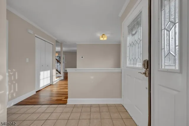 a view of an empty room with a fireplace and wooden floor