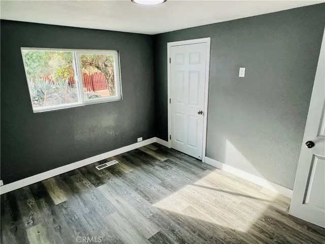 a view of a house with a yard chairs and a large tree