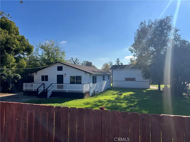 a view of a house with a yard and a patio