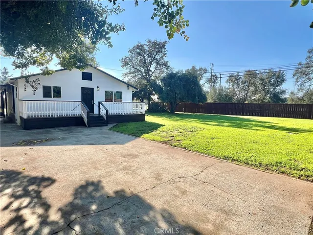 a backyard of a house with a yard and outdoor seating