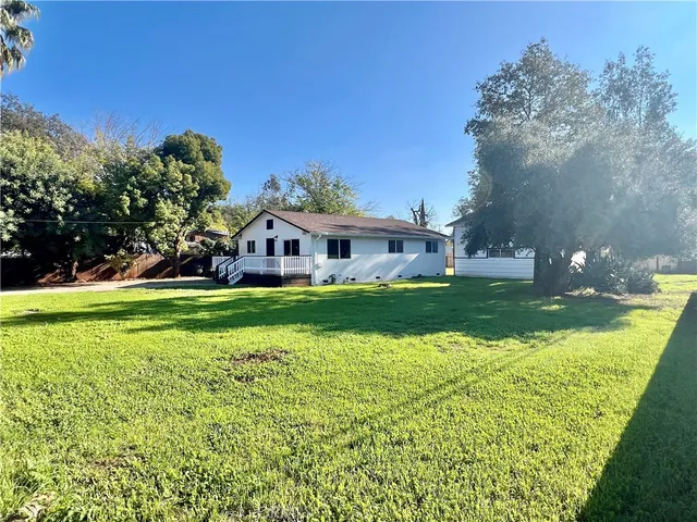 a view of house with garden space and trees