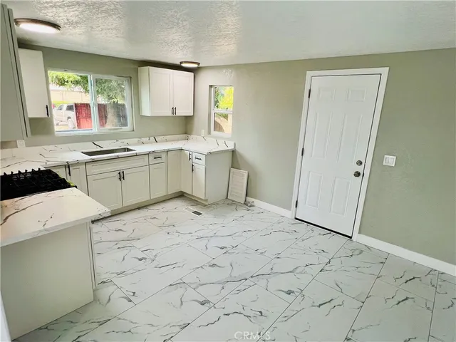 a kitchen with a stove a sink a refrigerator and window