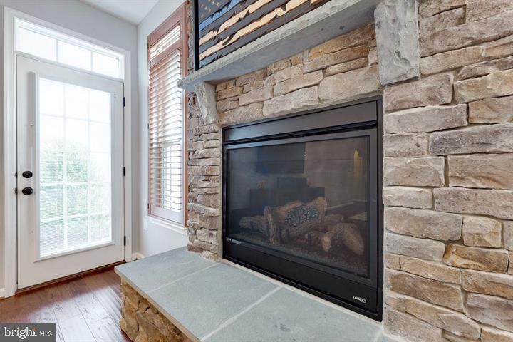 24876 Helms Terrace Aldie, VA 20105 - Photo 21 of 45 a view of an empty room with wooden floor and a fireplace