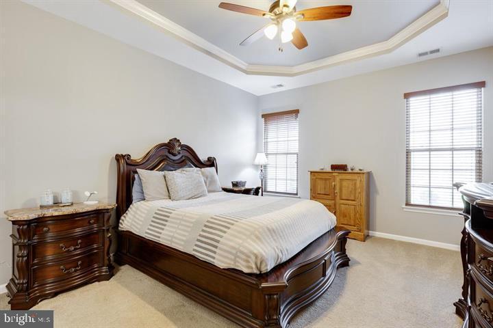 24876 Helms Terrace Aldie, VA 20105 - Photo 24 of 45 a bedroom with a bed and a chandelier