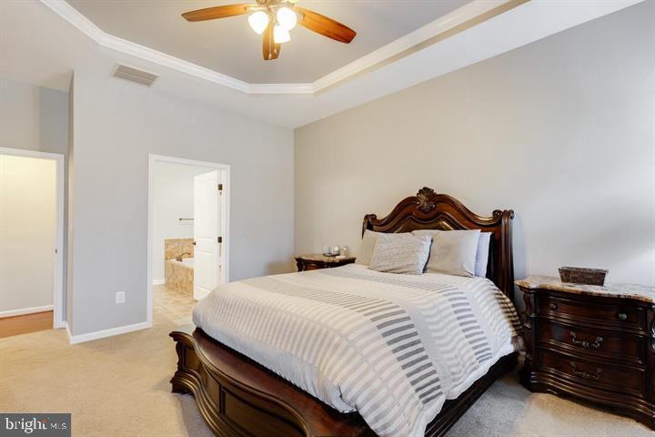 24876 Helms Terrace Aldie, VA 20105 - Photo 26 of 45 a bedroom with a bed and a chandelier