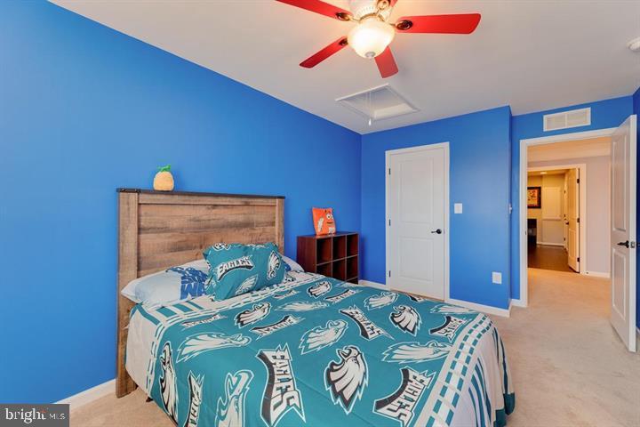 24876 Helms Terrace Aldie, VA 20105 - Photo 35 of 45 a bedroom with a bed and a chandelier