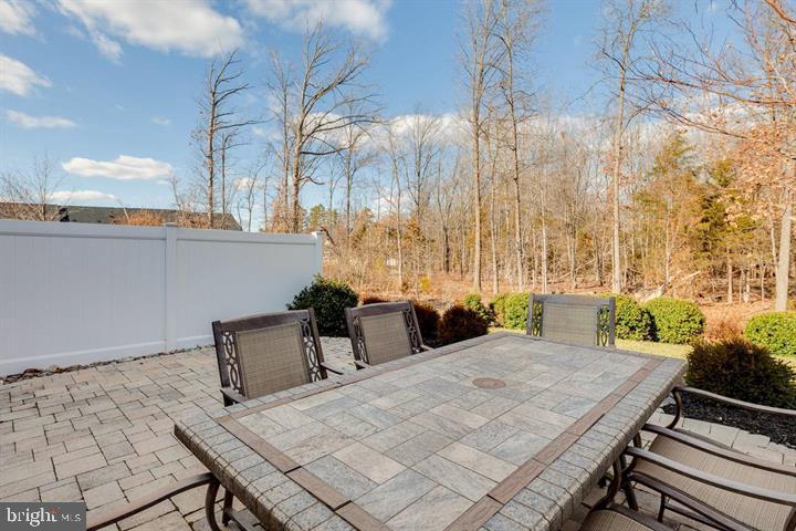 24876 Helms Terrace Aldie, VA 20105 - Photo 43 of 45 a view of a balcony with table and chairs and wooden fence