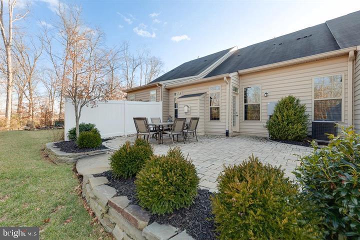 24876 Helms Terrace Aldie, VA 20105 - Photo 44 of 45 a view of a patio with table and chairs potted plants and large tree
