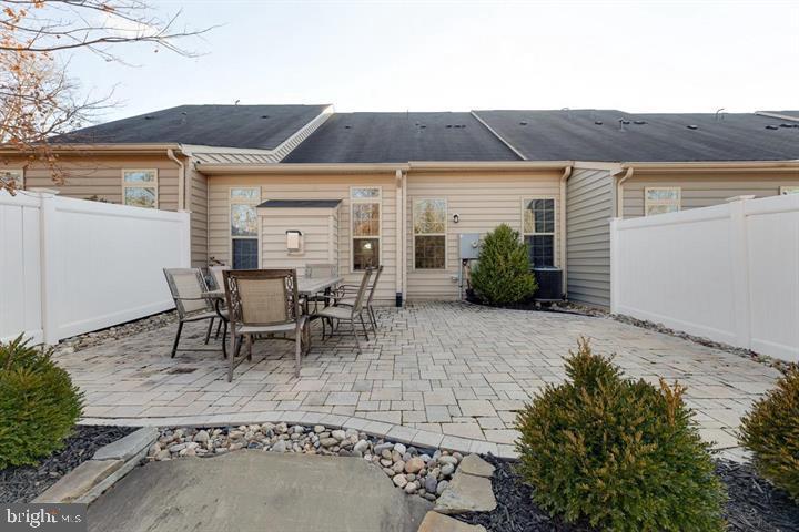 24876 Helms Terrace Aldie, VA 20105 - Photo 45 of 45 a view of a patio with table and chairs under an umbrella