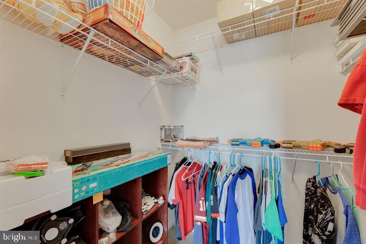 24876 Helms Terrace Aldie, VA 20105 - Photo 8 of 45 a view of walk in closet with clothes and shoes