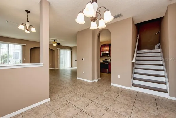 a view of a hallway with chandelier and entryway