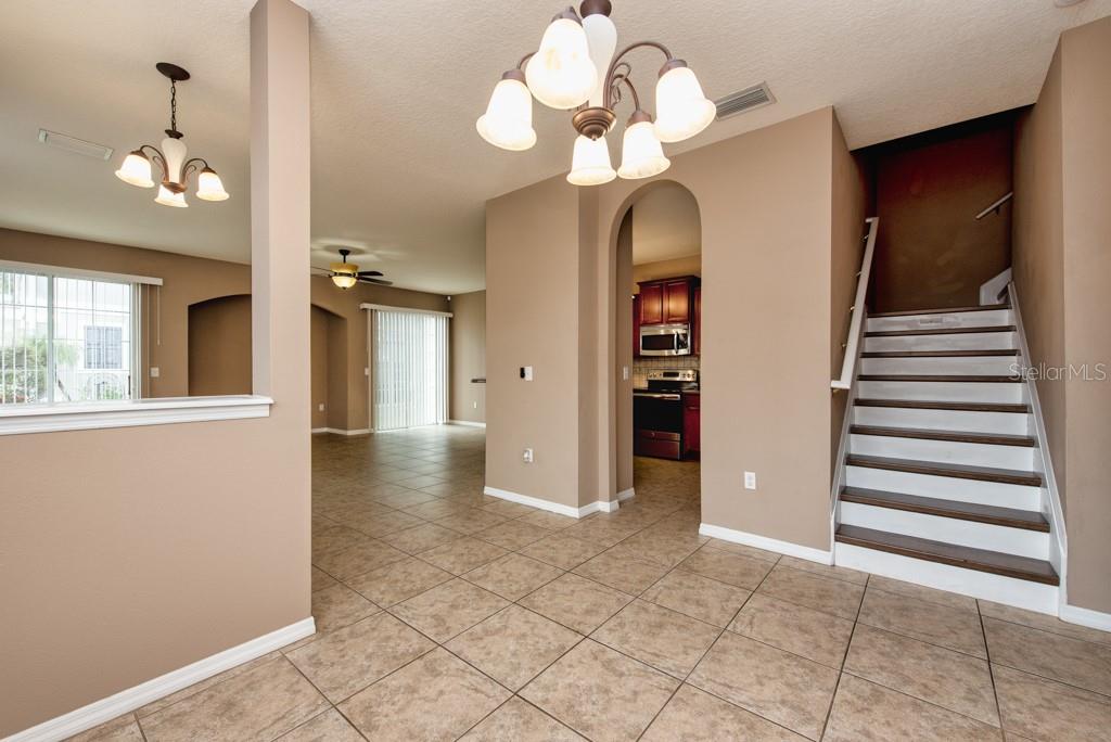 7525 Red Mill Circle New Port Richey, FL 34653 - Photo 15 of 41 a view of a hallway with chandelier and entryway