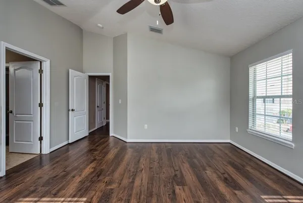 wooden floor in an empty room with a window