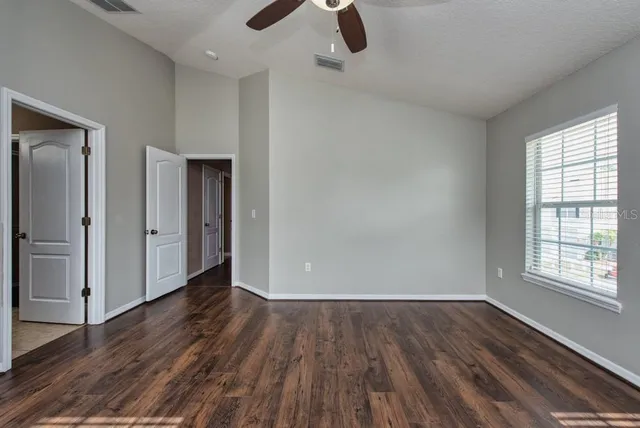 wooden floor in an empty room with a window