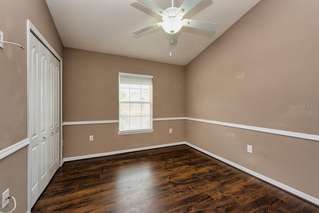 7525 Red Mill Circle New Port Richey, FL 34653 - Photo 23 of 41 an empty room with wooden floor and windows