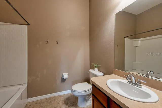 a bathroom with a sink toilet and a mirror
