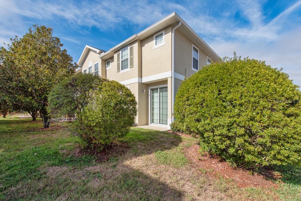 7525 Red Mill Circle New Port Richey, FL 34653 - Photo 28 of 41 a front view of a house with garden