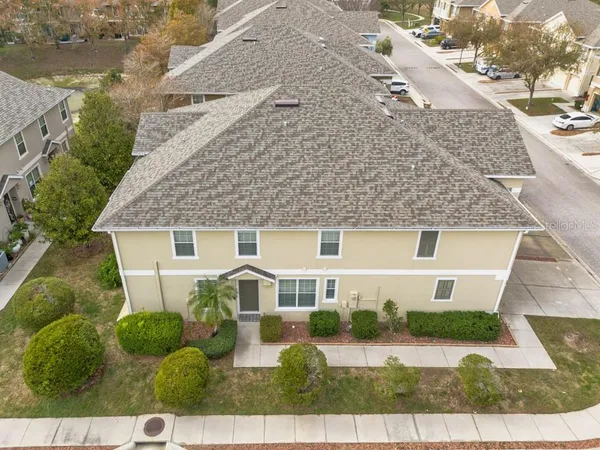 an aerial view of a house with a garden and lake view