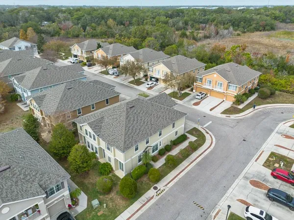 an aerial view of a house with a yard