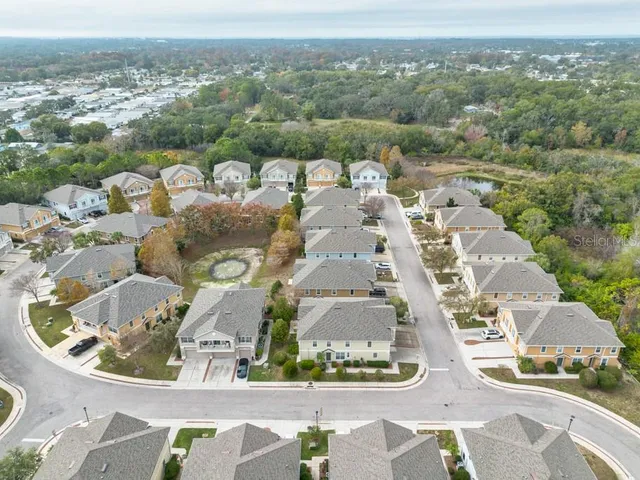 an aerial view of residential houses with outdoor space