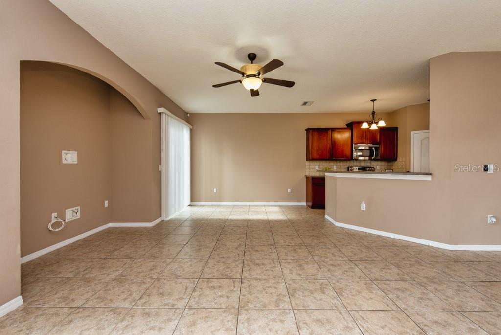 7525 Red Mill Circle New Port Richey, FL 34653 - Photo 5 of 41 a view of a kitchen with a sink and a microwave