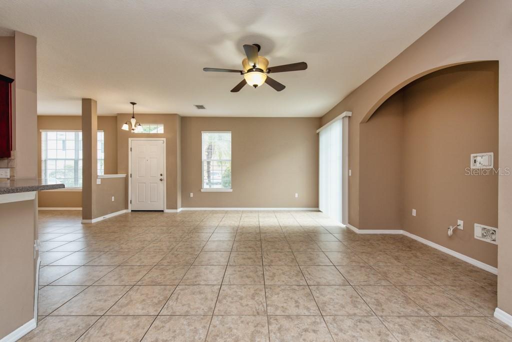 7525 Red Mill Circle New Port Richey, FL 34653 - Photo 7 of 41 a view of a livingroom with a chandelier fan and windows