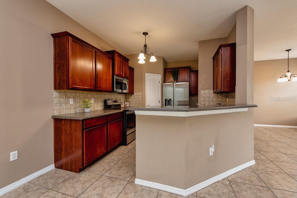 7525 Red Mill Circle New Port Richey, FL 34653 - Photo 8 of 41 a bathroom with a sink and a large mirror