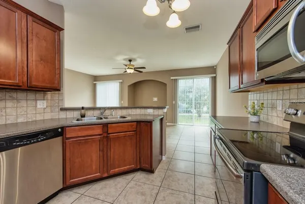 a kitchen with a sink stove top oven and cabinets