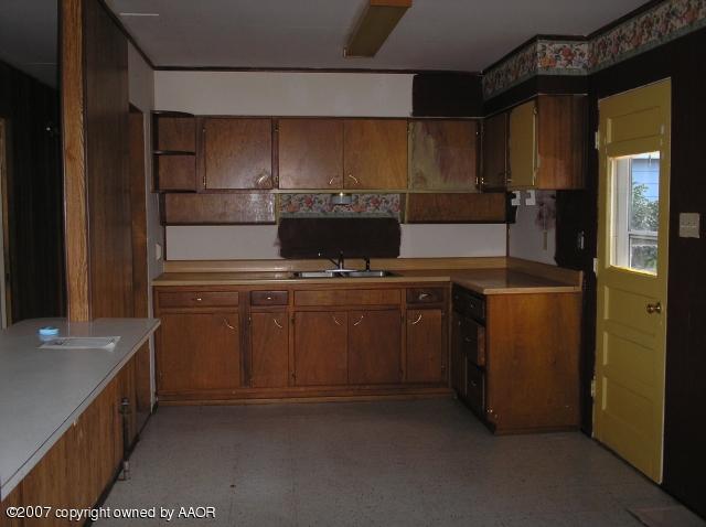 5024 South Bonham Street Amarillo, TX 79110 - Photo 2 of 4 a kitchen with a stove and a refrigerator
