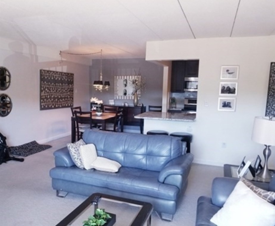 40 Main Street, Unit 308 Stoneham, MA 02180 - Photo 3 of 10 a living room with furniture and kitchen view