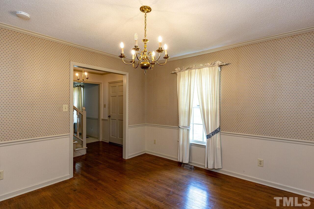 7413 Old Fox Trail Raleigh, NC 27613 - Photo 7 of 47 a view of a livingroom with wooden floor and door