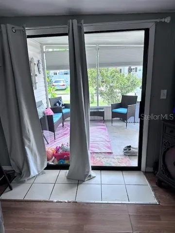 a view of outdoor space with dining area window and wooden floor