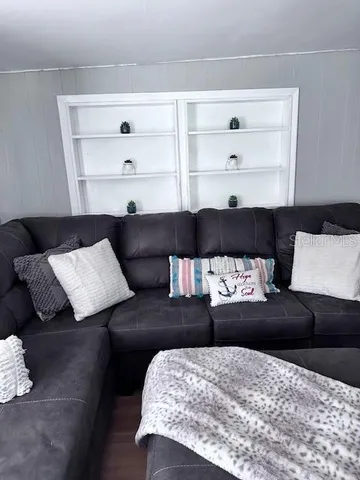 a living room with a couch and a bookshelf