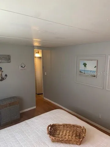 a view of a room with wooden floor and a window