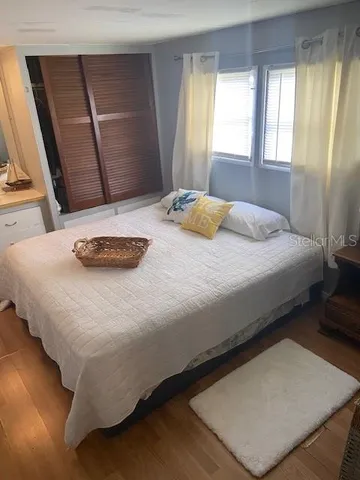 a bedroom with a bed and window