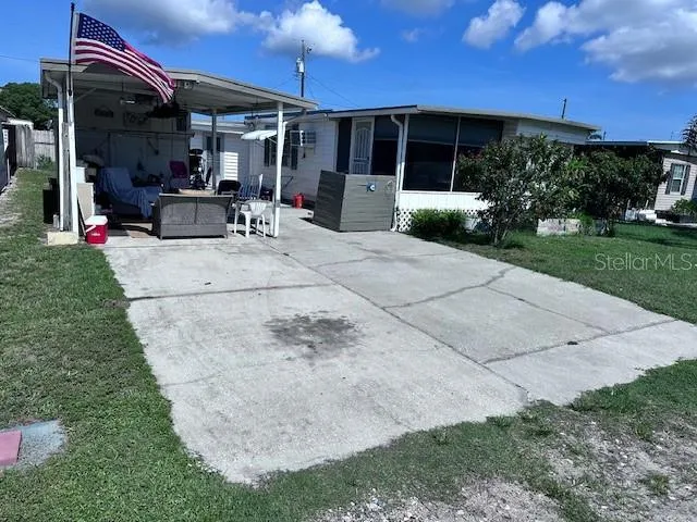 a view of a patio with table and chairs with wooden fence