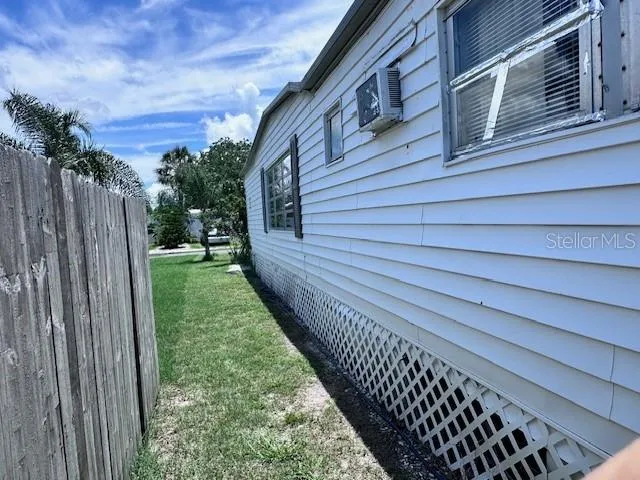 a view of a yard with wooden fence