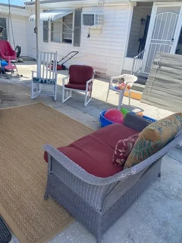 a view of an outdoor sitting area with brick walls