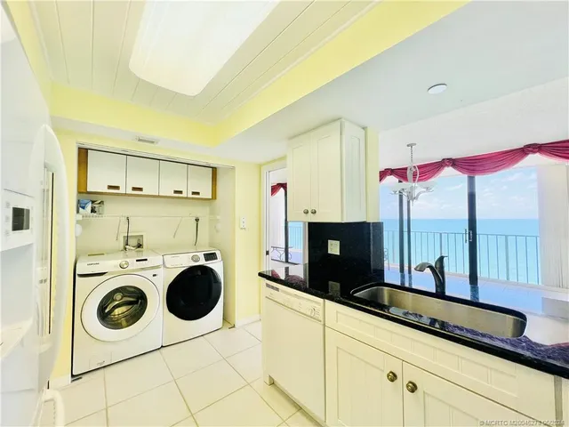 a view of a living room and chandelier