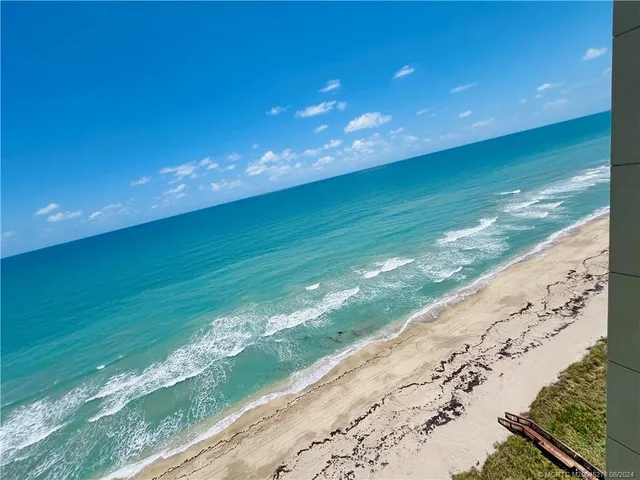a spacious bathroom with a shower a sink and a mirror
