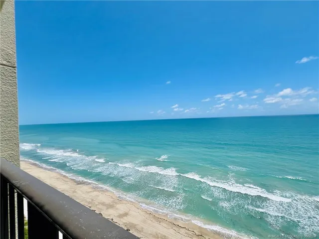 an empty room with large windows