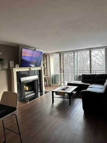 a living room with furniture fireplace and window