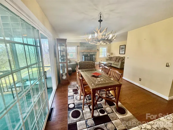 a view of a dining room with furniture wooden floor and chandelier